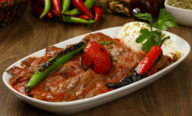 Turkish Iskender kebab with yoghurt and french fries